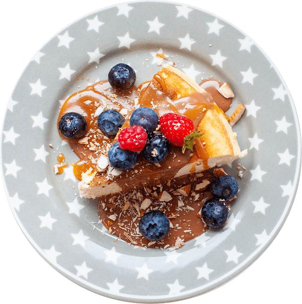 Cheesecake with berries and sauce on plate